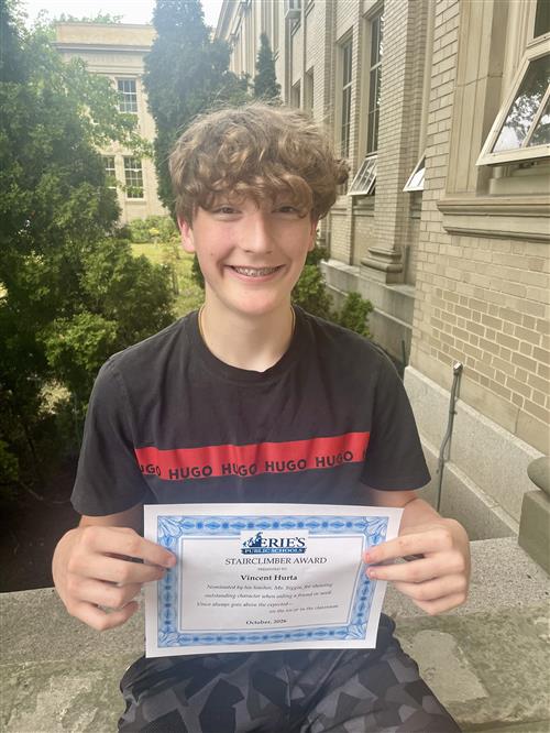 Vincent Hurta, Vincent's Stairclimber for October, poses with his award plaque.